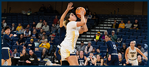 women's basketball player shooting a three pointer